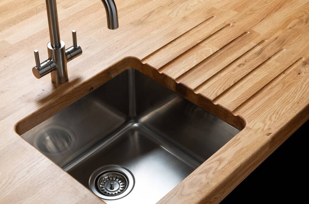oak worktop with a sink and drainage grooves